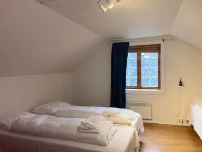 a bedroom with two beds and a window at Winjum Apartments Aurland Stegastein in Aurland