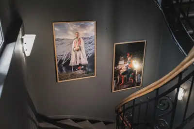 a staircase with three pictures on a wall at Heimen Hotel in Bergen