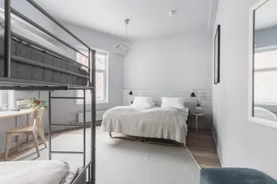 a bedroom with a bunk bed and a desk at Heimen Hotel in Bergen