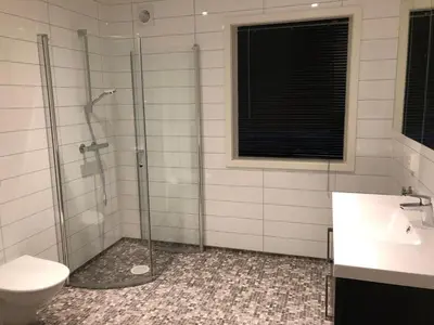 a bathroom with a shower and a toilet at Balestrand Fjordapartments in Balestrand
