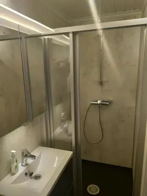 a bathroom with a shower with a sink and a shower at Sogndal ski- and mountain cabin in Sogndal