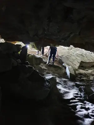 a group of people walking through a cave at Vestavind hytter og rom AS in Ålesund
