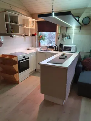 a kitchen with a stove and a counter top at Vestavind hytter og rom AS in Ålesund