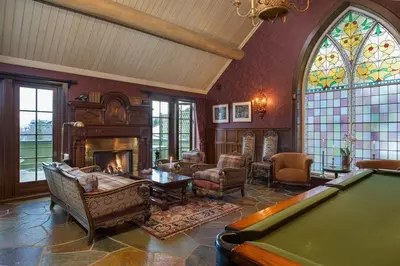 a living room with a pool table and a fireplace at Geilo Mountain Lodge in Geilo