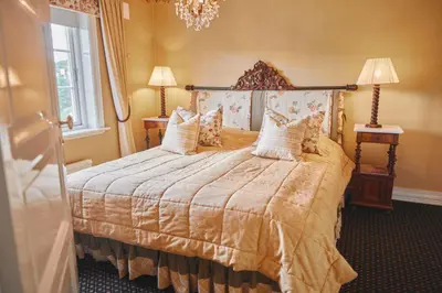 a bedroom with a bed and a chandelier at Geilo Mountain Lodge in Geilo