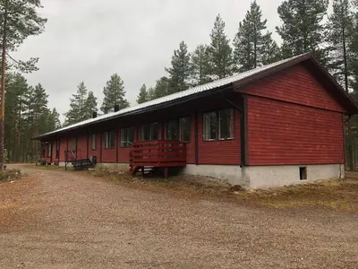 a red building in the middle of a forest at Rena HOSTEL EINARA in Rena