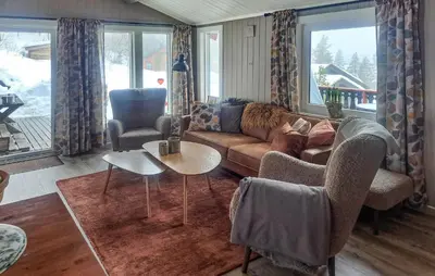 a living room with a couch and a table at Four-Bedroom Holiday Home In Rendalen in Rendalen