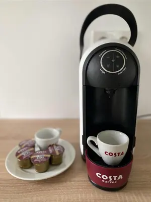 a coffee maker and two cups on a table at Mjøsvang Kafe in Vang I Valdres
