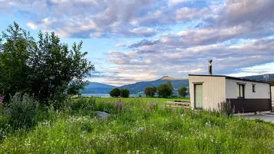 a small building in the middle of a field at Mjøsvang Kafe in Vang I Valdres