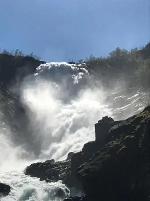 a view of a river with clouds in the sky at Vatnahalsen Høyfjellshotell in Myrdal