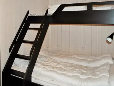 a bunk bed with a ladder in a room at 10 person holiday home in Øyer in Øyer