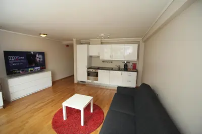 a living room with a couch and a table at Bergen's Best Location in Bergen