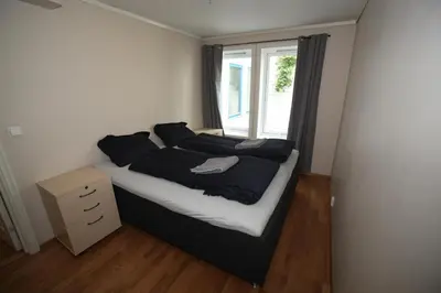 a bedroom with a large bed with a window at Bergen's Best Location in Bergen