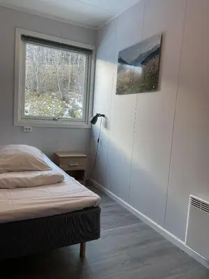 a bedroom with a bed and a window at Hardangerpark AS in Kinsarvik