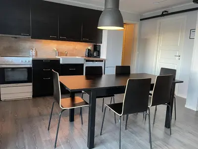 a kitchen with a dining room table and chairs at Hardangerpark AS in Kinsarvik