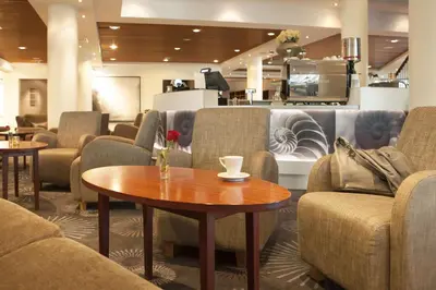 a waiting room with couches and a coffee table at Scandic Seilet Hotel in Molde