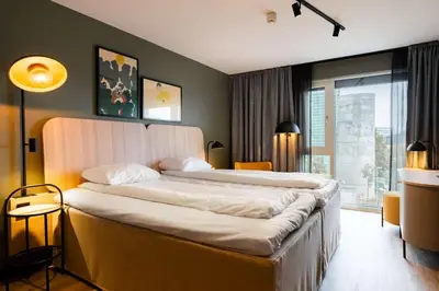 a hotel room with two beds and a window at Scandic Nidelven in Trondheim