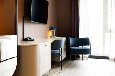 a hotel room with a desk and two chairs at Scandic Nidelven in Trondheim