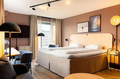 a hotel room with a large bed in a room at Scandic Nidelven in Trondheim