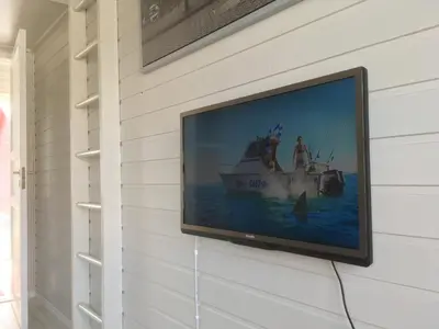 a flat screen tv hanging on a wall at Bergen Camping Park in Bergen