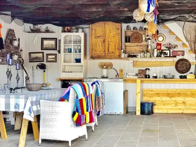 a kitchen with a table and a stove top oven at 6 person holiday home in Urangsvåg in Steinsbø