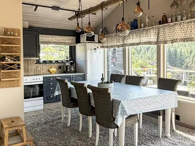 a kitchen with a dining room table and chairs at 6 person holiday home in Urangsvåg in Steinsbø