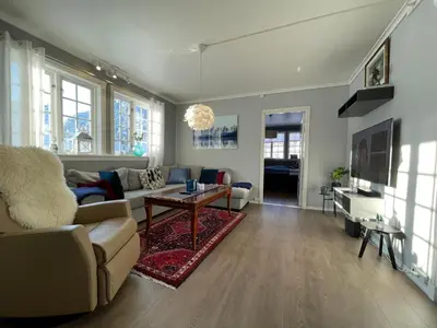a living room with a couch and a table at Høyanger 3 roms leilighet in Høyanger