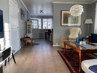 a living room with a couch and a table at Høyanger 3 roms leilighet in Høyanger