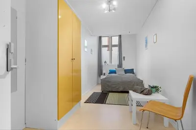 a bedroom with a bed and a table and a chair at Fabryka in Bergen
