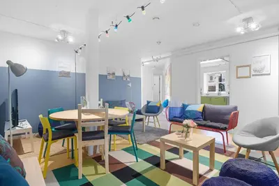 a living room with a table and chairs at Fabryka in Bergen