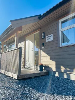 a front porch of a house with a sign on it at Fjellsporthytta nr. 4 in Sogndal