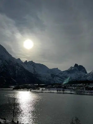 a view of a lake with snow covered mountains at Frichs Ekspress Åndalsnes in Åndalsnes