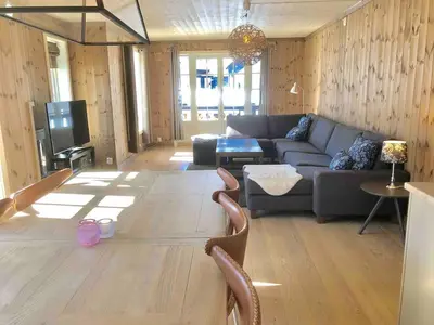 a living room with a couch and a tv at Kilen Lodge in Gaustablikk