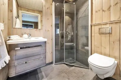 a bathroom with a shower and a toilet and a sink at Kilen Lodge in Gaustablikk