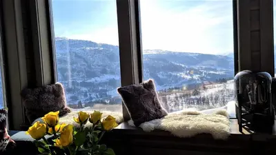 a window with a view of a snowy mountain at Timblalodgen in Sogndal