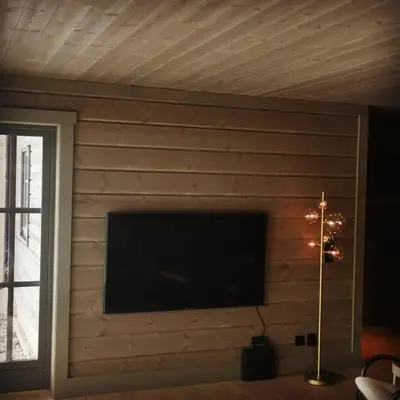 a brick wall with a flat screen tv on it at Timblalodgen in Sogndal
