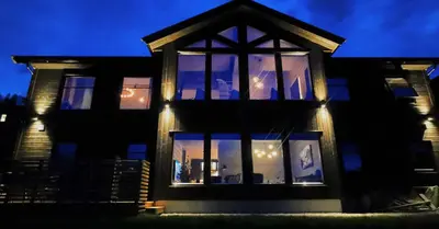 a house lit up at night with lights at Timblalodgen in Sogndal