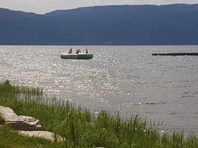 a group of people in a raft in the water at Utvika Camping in Nes