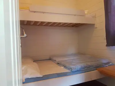 a small room with a bed in a cabin at Utvika Camping in Nes
