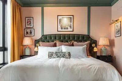 a bedroom with a large white bed with two lamps at Fýri Resort in Hemsedal