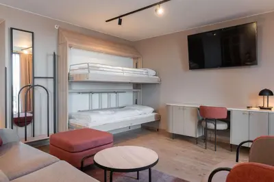 a living room with a bunk bed and a couch at Scandic Hamar in Hamar