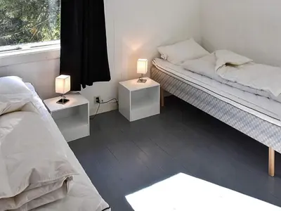 two beds in a room with two lamps on tables at 10 person holiday home in skei i jølster in Årdal