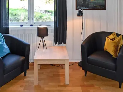 two chairs and a coffee table in a living room at 10 person holiday home in skei i jølster in Årdal