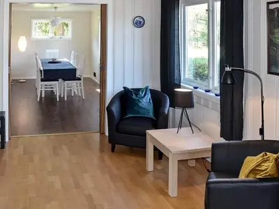 a living room with a chair and a table at 10 person holiday home in skei i jølster in Årdal