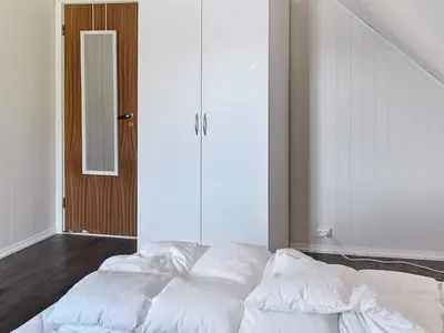 a bed with white sheets in a room at 10 person holiday home in skei i jølster in Årdal