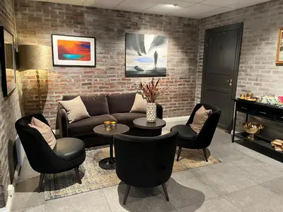a living room with a couch and chairs and a table at Aksjemøllen - by Classic Norway Hotels in Lillehammer