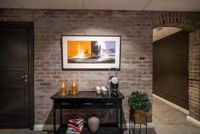 a black table in a room with a brick wall at Aksjemøllen - by Classic Norway Hotels in Lillehammer