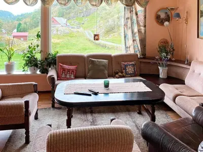 a living room with a couch and a coffee table at 9 person holiday home in Reksteren in Haukafer