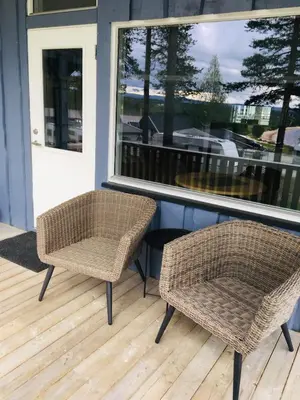 two chairs sitting on a porch next to a window at Osensjøen Camping in Valmen