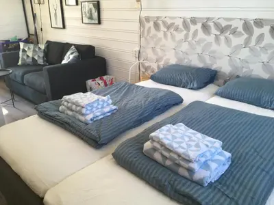 three beds with pillows on them in a room at Osensjøen Camping in Valmen
